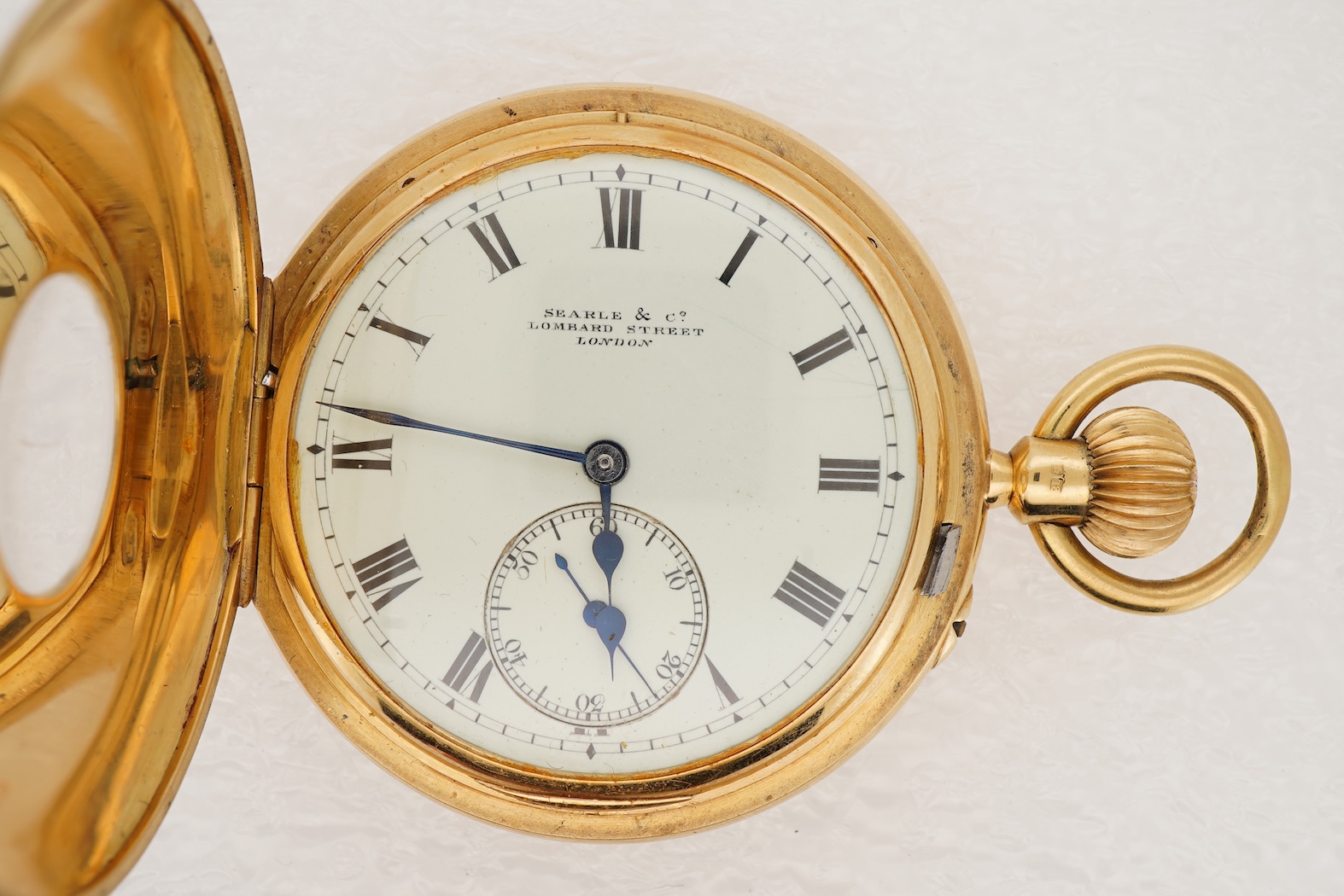 An Edwardian 18ct gold half hunter keyless lever pocket watch, by Searle & Co, Lombard Street, London
